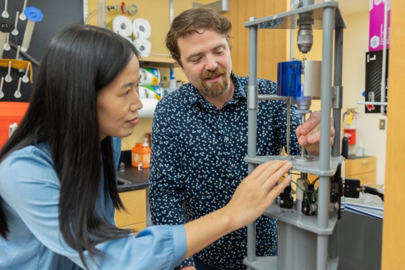 (From left) Xiaoting Jia and Dan English work in the Center for Photonics Technology. Photo by Ben Murphy for Virginia Tech.