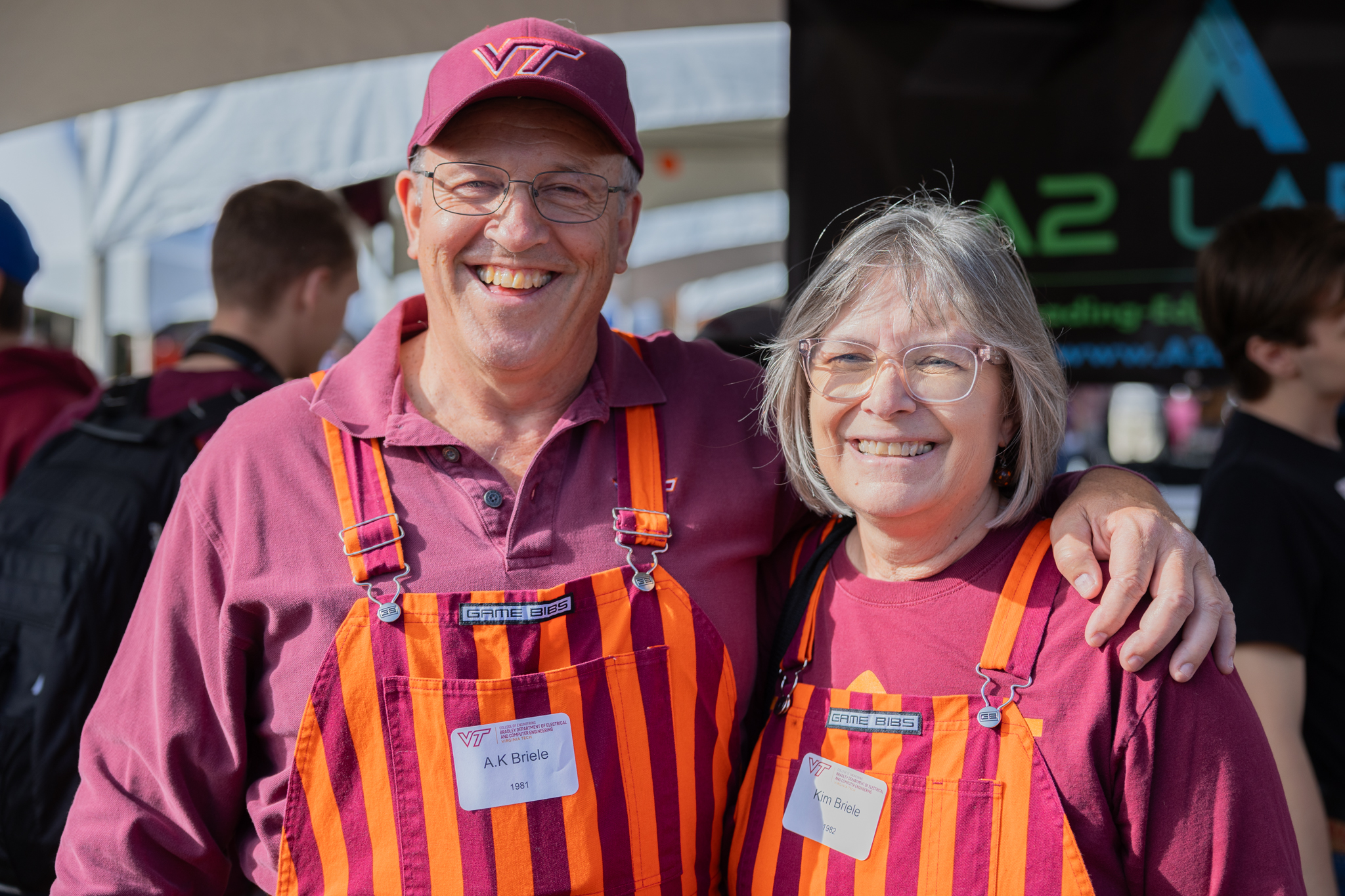 Two Virginia Tech ECE alumni smile at a tailgate!