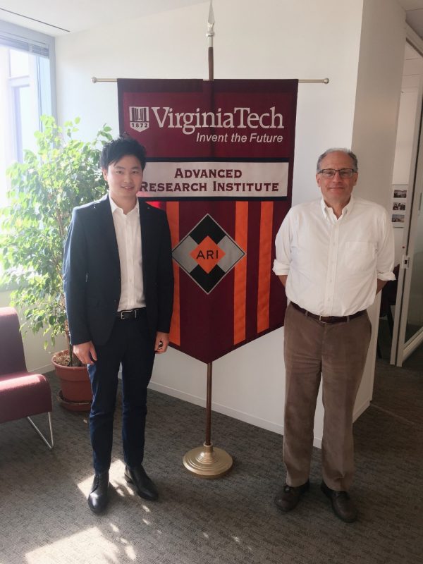 Junbo Zhao and Lamine Mili standing in front of sign at VT Research Center