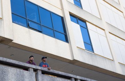 Tarun Cousik and Rohit Rangaraj stare majestically into the distance from a Whittemore Hall balcony.