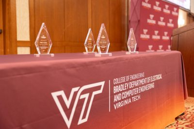 Bradley Department of Electrical and Computer Engineering tablecloth with distinguished alumni trophies.