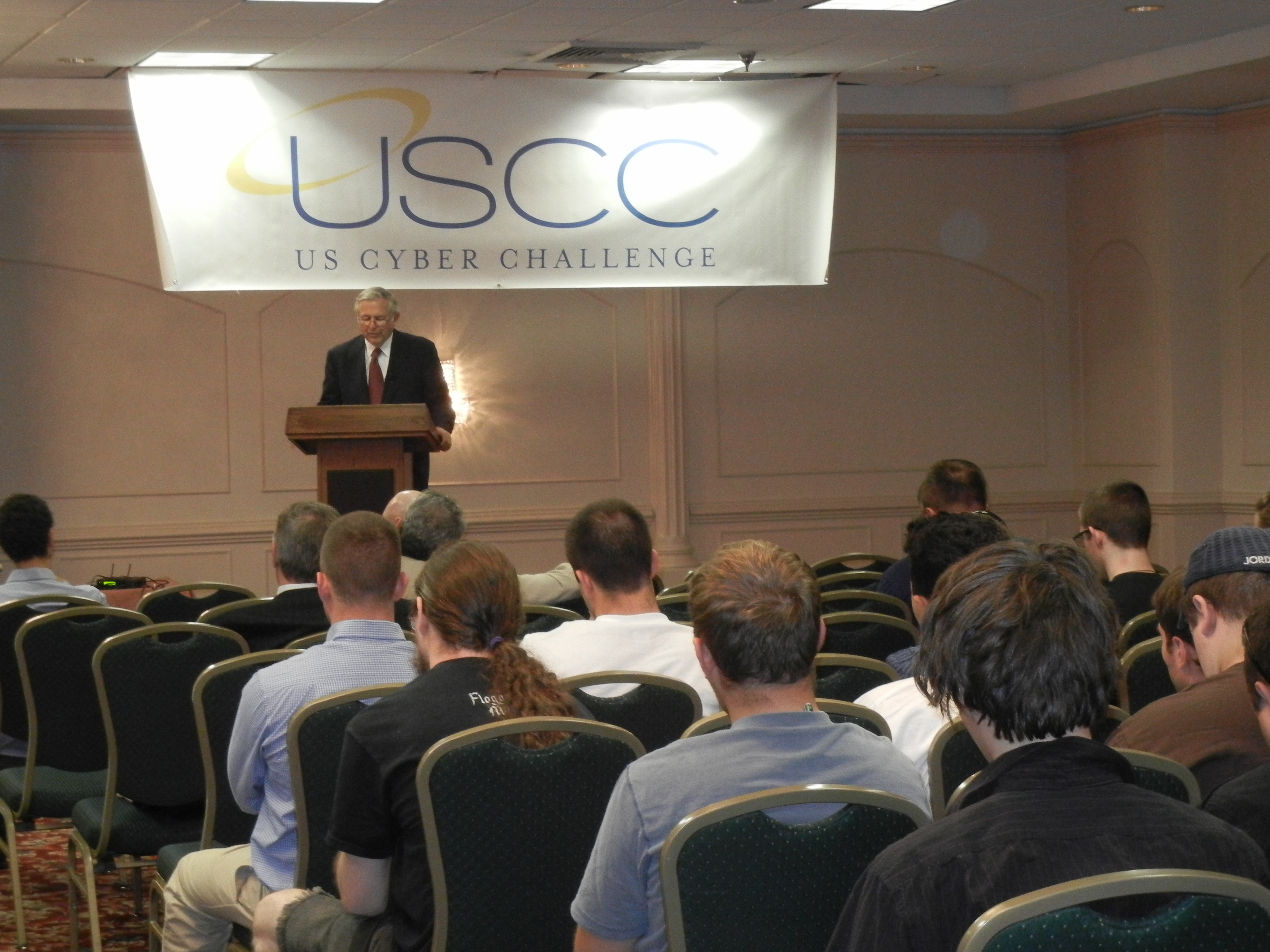 Charles W. Steger pictured speaking to audience of summer cyber camp participants