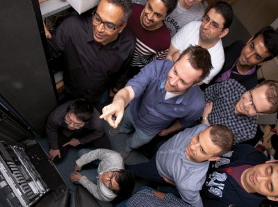 Binoy Ravindran (top left), Pierre Olivier (center) and a team of graduate students are working to improve security for applications that share hardware resources with other applications. 