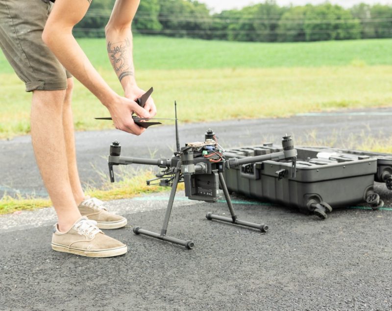 Student sets up drone in a field