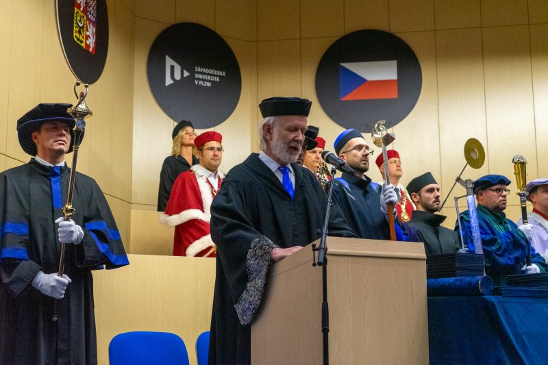 Professor addresses the crowd from a podium at an international university.